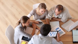 Upper view of business people around table